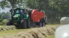 KUHN VBP 3260 baler-wrapper combination at work in a field full of wrapped bales.